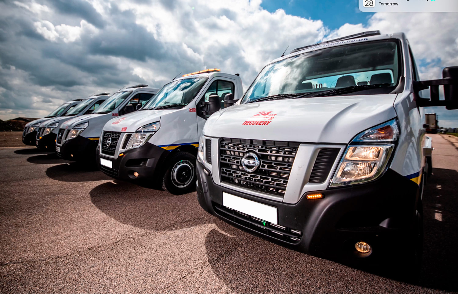 Image shows a line of recovery trucks